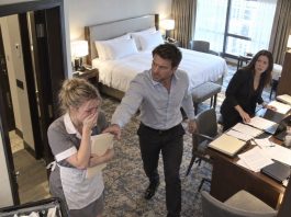 I smiled as I knocked on my husband’s hotel room door, convinced my secret maid disguise would make his night. Seconds later, the door opened—and one shocking sight changed everything I thought I knew about my marriage.