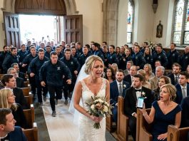 The night before my wedding, Mom called all 94 guests and told them, The whole family agrees we’re not going. Don’t be the only one there. On my wedding day, I started walking down the aisle alone—until the back doors suddenly opened and 200 strangers in matching jackets walked in. The pastor froze. Then Mom’s phone buzzed: Turn around. Your daughter’s groom is…