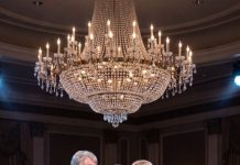 When the bride violently ripped my cancer-stricken wife’s wig off at the wedding, she expected everyone to laugh. Instead, I stepped onto the stage, opened a sealed legal envelope, and watched her face turn completely pale.