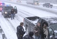 On my way to family dinner in a blizzard, I spotted a barefoot little girl staggering down the highway. I slammed the brakes and carried her to my truck. “Please don’t send me back,” she said, clinging to my sleeve and shaking. Five minutes later, the police stopped me because…