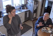 My sister called me at dawn, hysterically announcing our father’s death. There was just one problem—Dad was sitting in my kitchen, eating breakfast. When I told him, his hands began shaking. “Don’t tell her I’m here,” he whispered. “She’s been lying to both of us.” Then he showed me what he’d discovered the night before…