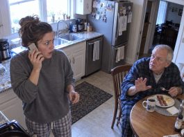 My sister called me at dawn, hysterically announcing our father’s death. There was just one problem—Dad was sitting in my kitchen, eating breakfast. When I told him, his hands began shaking. “Don’t tell her I’m here,” he whispered. “She’s been lying to both of us.” Then he showed me what he’d discovered the night before…