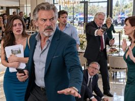 At my daughter’s housewarming, her father-in-law stopped me as I prepared to speak. “Sit down. Someone like you doesn’t belong here.” Everyone became silent. I smiled, lifted my phone, and said, “Freeze the position. Freeze all of it.” His face gave away everything. The perfect revenge…