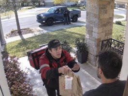 A food delivery driver ran to my door, terrified. He shoved the bag at me and whispered, “Don’t eat this. They paid me to deliver it. They’re in the blue truck. They showed me a gun. If you’re reading this, your son is…” His voice failed. The truck’s headlights flashed twice. Someone got out holding a terrifying thing. A red dot appeared on my head. What happened next is…