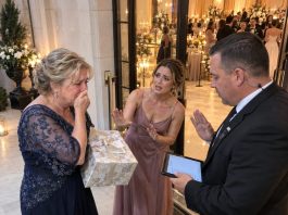 At my adopted daughter’s wedding, the guard looked at my photo, looked at me, and said, “I’m sorry, ma’am—you’re not allowed inside.” I turned around and left, but before the night was over, her father-in-law called with a warning that made my hands go cold: “They’re heading to your house now. Do not answer the door.”