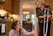Fourteen relatives expected dinner. My mother expected my injured wife to crawl across the kitchen to prepare it. Watching the video from thirty thousand feet, I saw Clara reaching for the crutches my mother refused to return. Then something behind her changed everything: an object tied to my grandmother’s warning and a family history nobody had ever explained to me…