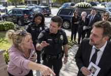 My neighbor called the police during my own son’s funeral because the cars parked outside were supposedly blocking her driveway, showing absolutely no respect for a family already shattered by grief. She stood there demanding that everyone move, completely unaware of who she had just called the authorities on—and the moment the officers learned the truth, everything took a turn she never saw coming.
