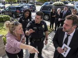 My neighbor called the police during my own son’s funeral because the cars parked outside were supposedly blocking her driveway, showing absolutely no respect for a family already shattered by grief. She stood there demanding that everyone move, completely unaware of who she had just called the authorities on—and the moment the officers learned the truth, everything took a turn she never saw coming.