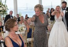 Years ago, I sacrificed my body to pull my sister Emily from a fiery death, leaving me scarred and wheelchair-bound. At her high-end Charleston wedding today, she had my seat tucked away behind a curtain to keep her wealthy guests from seeing me. “You’ll ruin the photos,” she muttered. Suddenly, our mother rose, lifted her glass, and proclaimed, “Before we celebrate Emily, everyone deserves to know who paid the price for this wedding…”