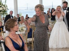 Years ago, I sacrificed my body to pull my sister Emily from a fiery death, leaving me scarred and wheelchair-bound. At her high-end Charleston wedding today, she had my seat tucked away behind a curtain to keep her wealthy guests from seeing me. “You’ll ruin the photos,” she muttered. Suddenly, our mother rose, lifted her glass, and proclaimed, “Before we celebrate Emily, everyone deserves to know who paid the price for this wedding…”