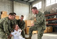 As three sailors held me helpless against the depot floor, Petty Officer Nolan Pierce stomped his boot straight into my right leg, echoing a sharp crack across the warehouse. His follow-up strike broke my left leg into pieces while the group laughed loudly over my pain, confident they had ruined their commander’s career forever. However, when Nolan crouched down to call me pathetic, he had no idea why I met his glare with a smile.