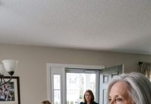 During Sunday breakfast right in front of my 9-year-old granddaughter, my greedy daughter-in-law violently slapped me across the face for refusing to hand over my lake house deed—sending my hearing aid flying across the floor. Brokenhearted, I calmly made two phone calls. Just 38 minutes later, a woman walked up my porch steps, and the moment my son saw who she was, he burst into tears… (True Story)