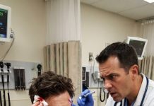 My heart shattered at my brother’s wedding when he smashed a glass bottle against my head, laughing, “Calm down, it’s just a prank!” Dizzy and covered in blood, I went straight to the ER. While cleaning the wound, the doctor suddenly stopped and whispered a shocking question. Four days later…