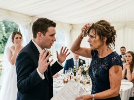 At my daughter’s wedding, her groom suddenly poured champagne over my head right in front of her. Everyone froze, but I didn’t lose my temper or say a word. I simply wiped my face, pulled out some documents, and revealed the secret he’d been desperately hiding. The moment he saw those papers, his face turned pale, and he started begging me…