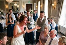 On my wedding day, I found the main table replaced—9 seats taken by my husband’s family while my parents were left standing. His mom sneered, “They look poor,” he agreed… so I made an announcement that ruined him instantly!
