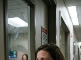 I rushed to the hospital to see my husband in intensive care. Suddenly, a nurse whispered: “Hide. Now. Trust me,” and pushed me away. Watching through the door crack, I saw another woman walk into his room. What I heard them whisper made my blood run ice-cold…